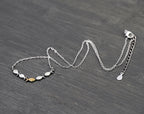 Swimming against the current. Dainty silver necklace. School of fish with one golden enameled fish swimming upstream. Gift for her.