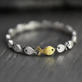Swimming against the current. Dainty sterling silver ring. School of fish with a golden one swimming upstream. Gift for her.