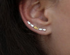 Ear climber Against The Current. Against the tide with one gold fish swimming upstream. Sterling silver fish earrings for her.